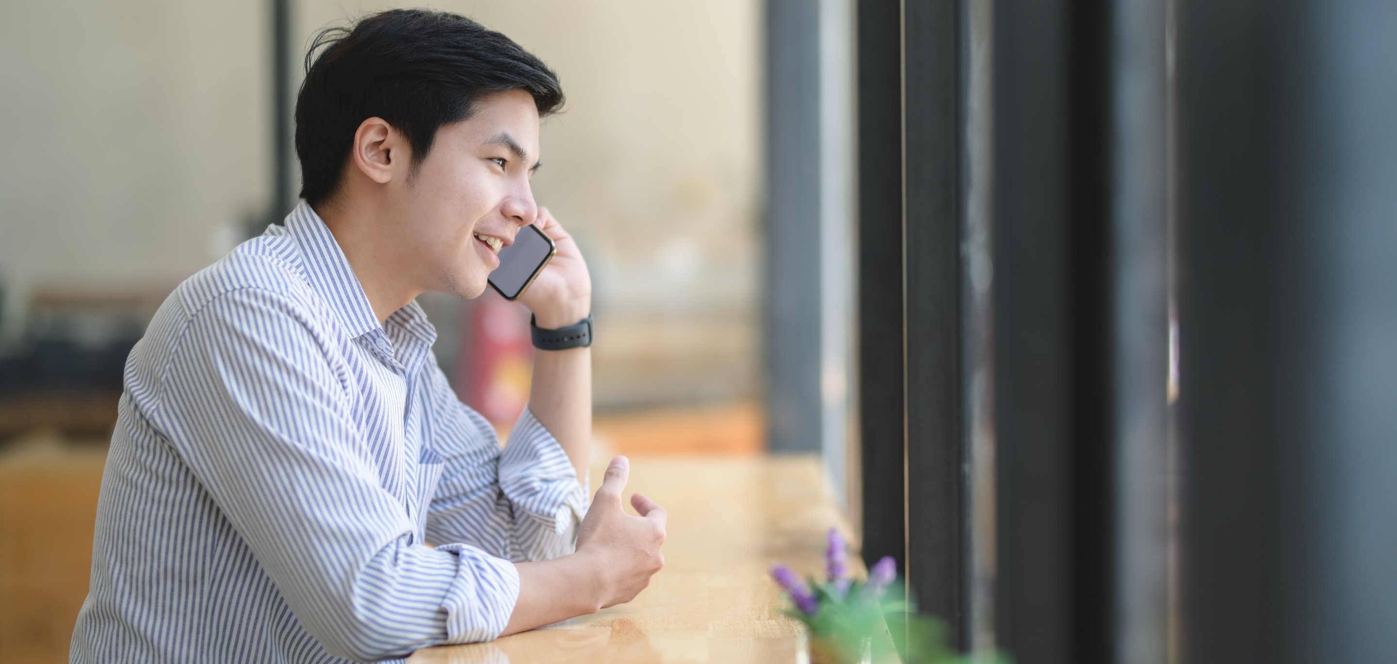 Man in White and Blue Dress Shirt Sitting by the Table